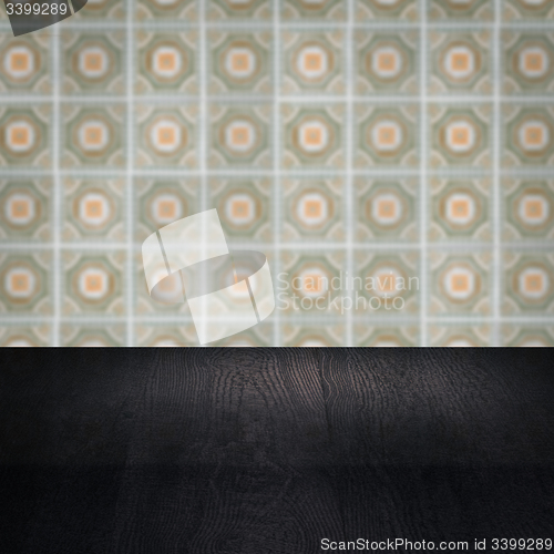 Image of Wood table top and blur vintage ceramic tile pattern wall