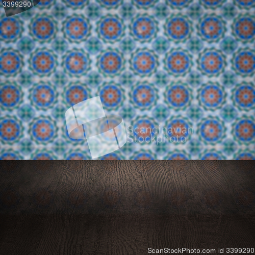 Image of Wood table top and blur vintage ceramic tile pattern wall