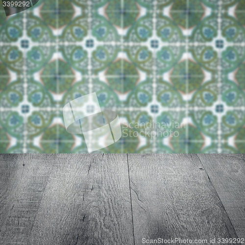 Image of Wood table top and blur vintage ceramic tile pattern wall