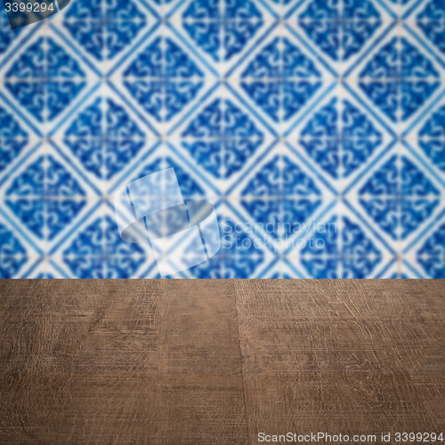 Image of Wood table top and blur vintage ceramic tile pattern wall