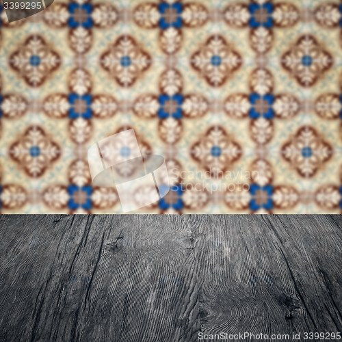 Image of Wood table top and blur vintage ceramic tile pattern wall