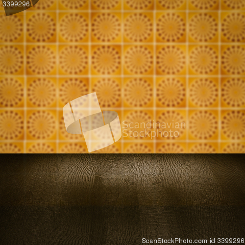 Image of Wood table top and blur vintage ceramic tile pattern wall