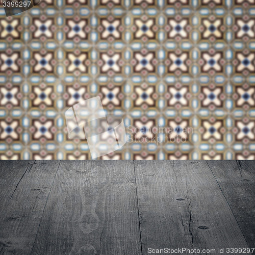 Image of Wood table top and blur vintage ceramic tile pattern wall