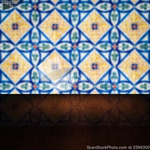 Image of Wood table top and blur vintage ceramic tile pattern wall