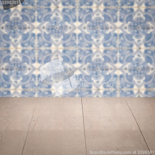 Image of Wood table top and blur vintage ceramic tile pattern wall