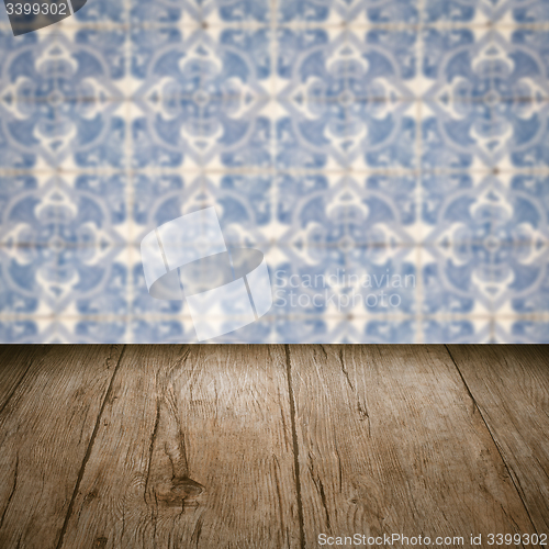 Image of Wood table top and blur vintage ceramic tile pattern wall