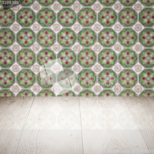 Image of Wood table top and blur vintage ceramic tile pattern wall