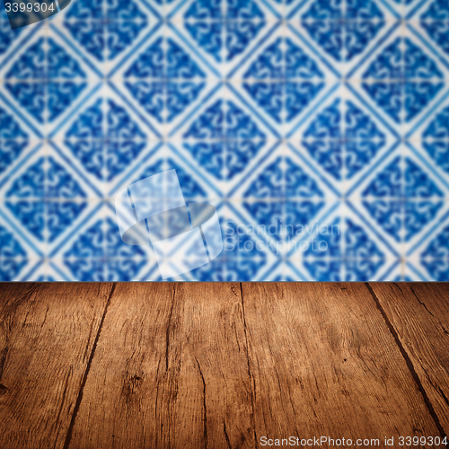 Image of Wood table top and blur vintage ceramic tile pattern wall