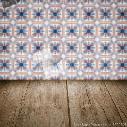 Image of Wood table top and blur vintage ceramic tile pattern wall