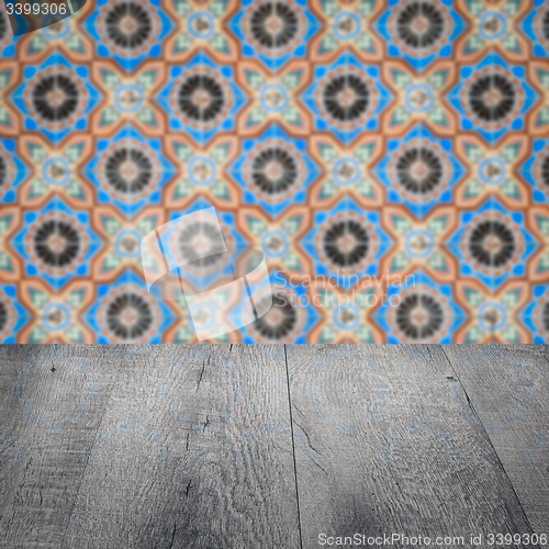 Image of Wood table top and blur vintage ceramic tile pattern wall