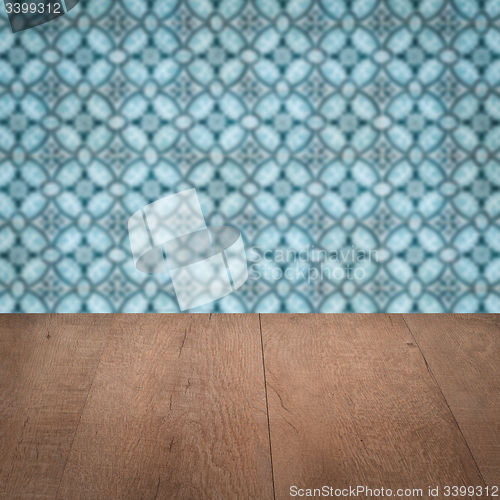 Image of Wood table top and blur vintage ceramic tile pattern wall