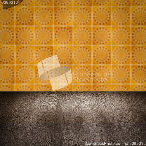 Image of Wood table top and blur vintage ceramic tile pattern wall