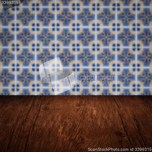 Image of Wood table top and blur vintage ceramic tile pattern wall