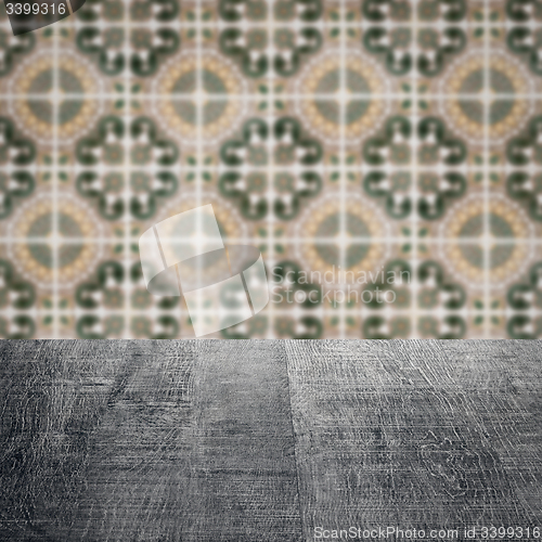 Image of Wood table top and blur vintage ceramic tile pattern wall