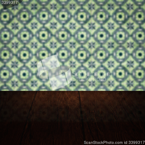 Image of Wood table top and blur vintage ceramic tile pattern wall