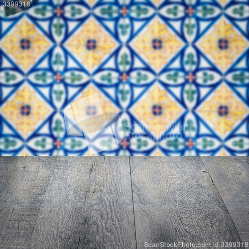 Image of Wood table top and blur vintage ceramic tile pattern wall
