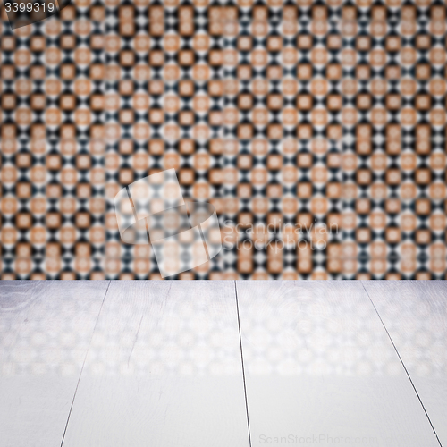 Image of Wood table top and blur vintage ceramic tile pattern wall