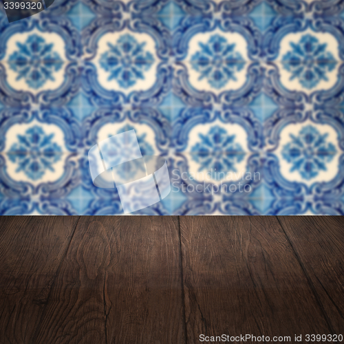 Image of Wood table top and blur vintage ceramic tile pattern wall