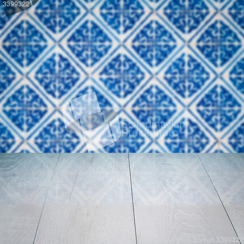 Image of Wood table top and blur vintage ceramic tile pattern wall