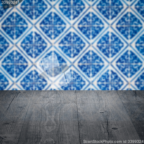 Image of Wood table top and blur vintage ceramic tile pattern wall
