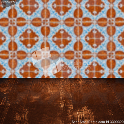 Image of Wood table top and blur vintage ceramic tile pattern wall