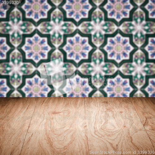 Image of Wood table top and blur vintage ceramic tile pattern wall