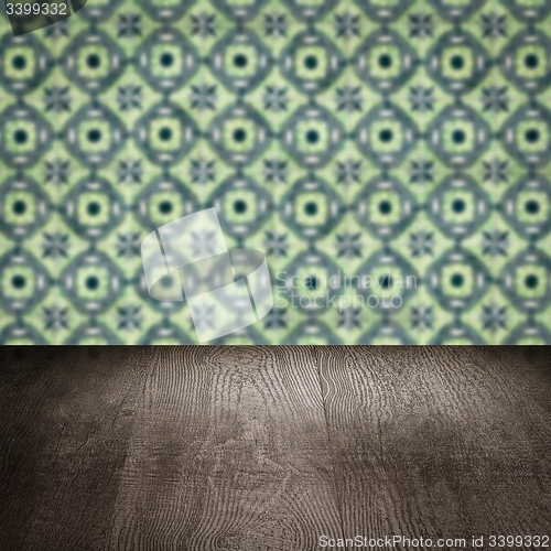 Image of Wood table top and blur vintage ceramic tile pattern wall