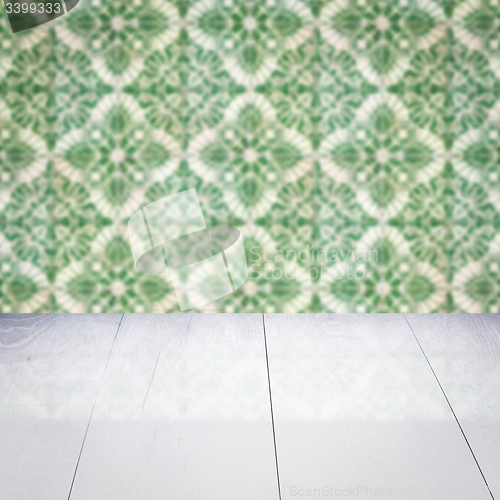 Image of Wood table top and blur vintage ceramic tile pattern wall