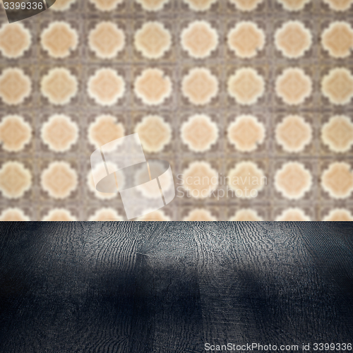 Image of Wood table top and blur vintage ceramic tile pattern wall