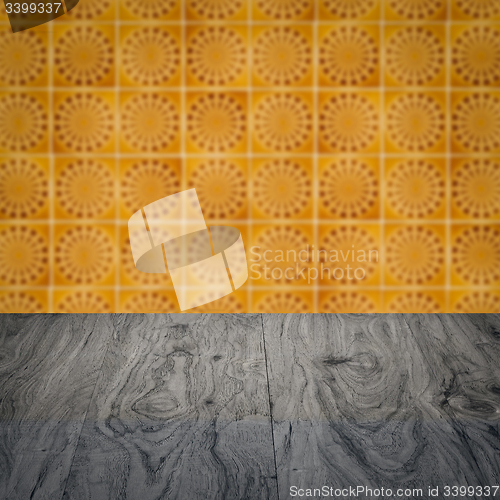 Image of Wood table top and blur vintage ceramic tile pattern wall