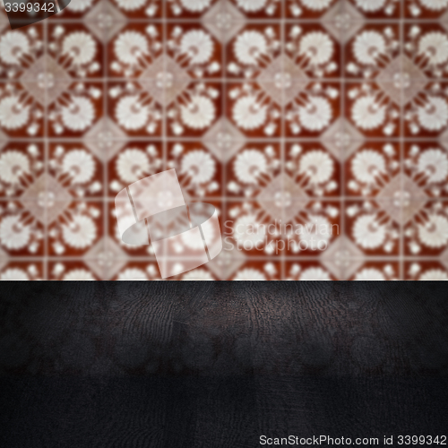 Image of Wood table top and blur vintage ceramic tile pattern wall