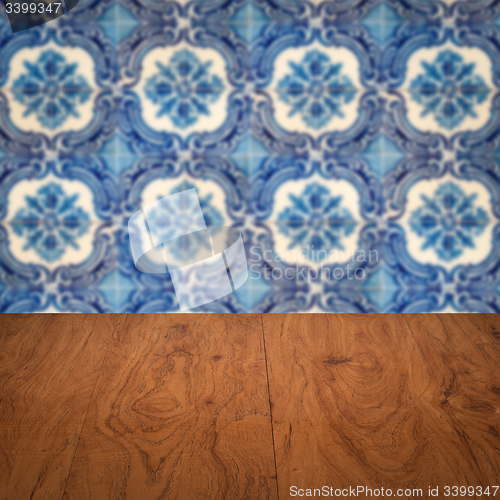 Image of Wood table top and blur vintage ceramic tile pattern wall