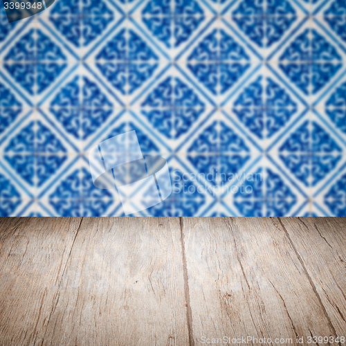 Image of Wood table top and blur vintage ceramic tile pattern wall