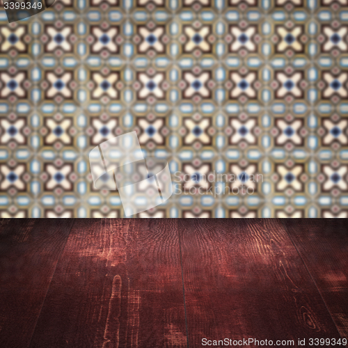 Image of Wood table top and blur vintage ceramic tile pattern wall