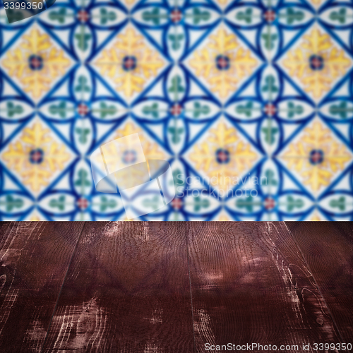 Image of Wood table top and blur vintage ceramic tile pattern wall