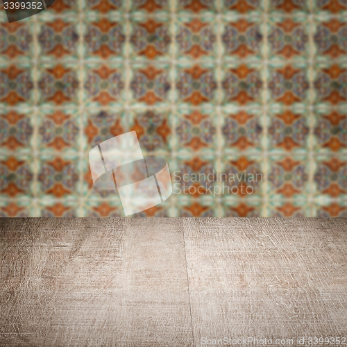 Image of Wood table top and blur vintage ceramic tile pattern wall