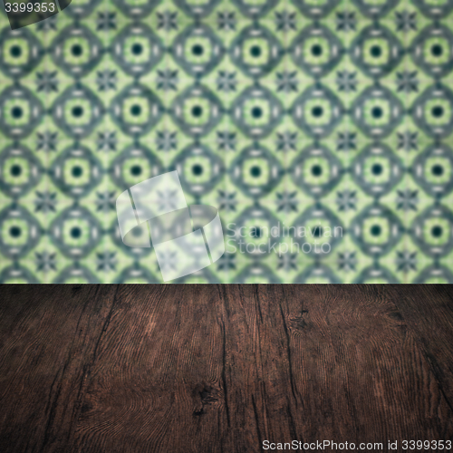 Image of Wood table top and blur vintage ceramic tile pattern wall