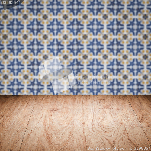 Image of Wood table top and blur vintage ceramic tile pattern wall