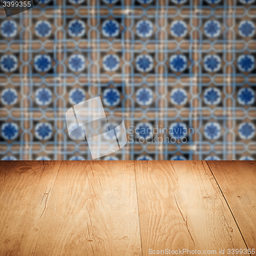 Image of Wood table top and blur vintage ceramic tile pattern wall