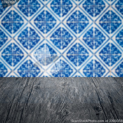 Image of Wood table top and blur vintage ceramic tile pattern wall