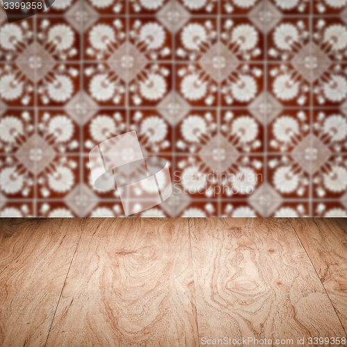 Image of Wood table top and blur vintage ceramic tile pattern wall