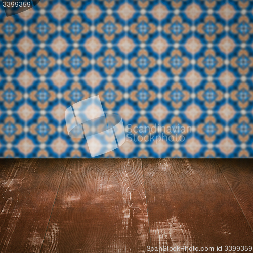 Image of Wood table top and blur vintage ceramic tile pattern wall