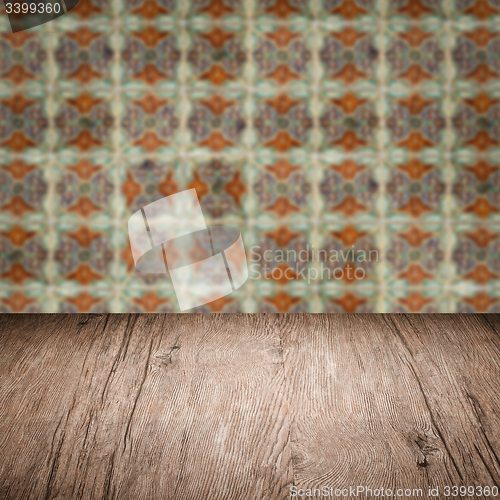 Image of Wood table top and blur vintage ceramic tile pattern wall