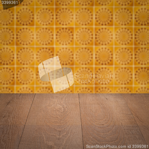 Image of Wood table top and blur vintage ceramic tile pattern wall