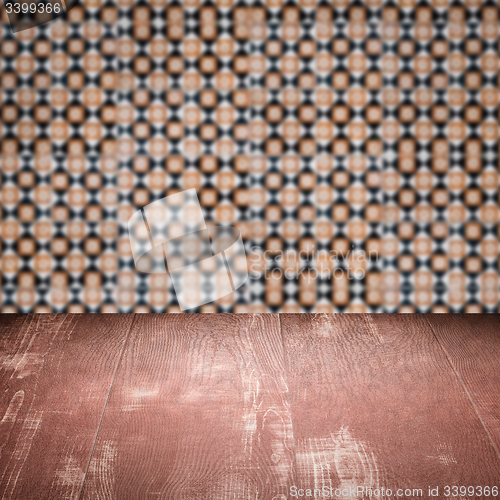 Image of Wood table top and blur vintage ceramic tile pattern wall