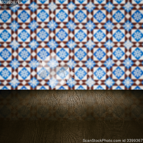 Image of Wood table top and blur vintage ceramic tile pattern wall