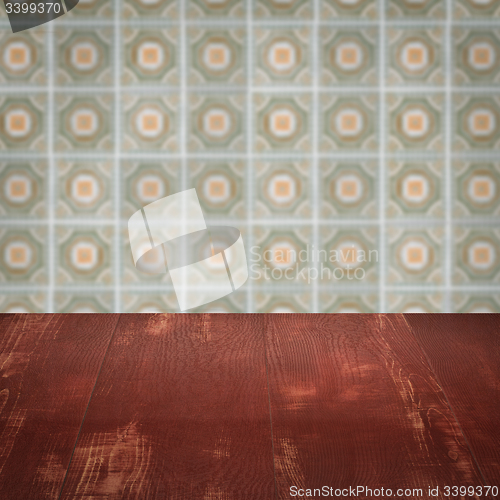 Image of Wood table top and blur vintage ceramic tile pattern wall