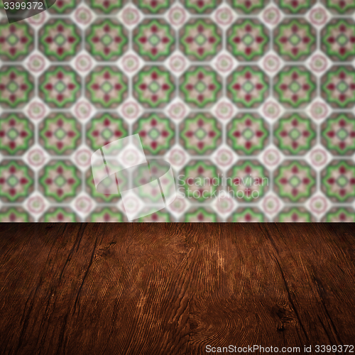 Image of Wood table top and blur vintage ceramic tile pattern wall