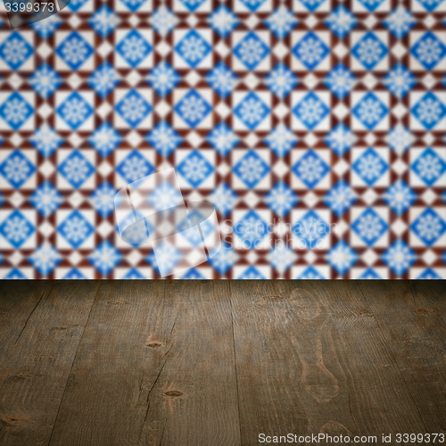 Image of Wood table top and blur vintage ceramic tile pattern wall