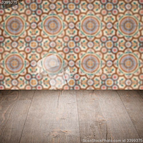 Image of Wood table top and blur vintage ceramic tile pattern wall